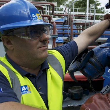 Adler and Alan employee wearing a high vis vest and hardhat